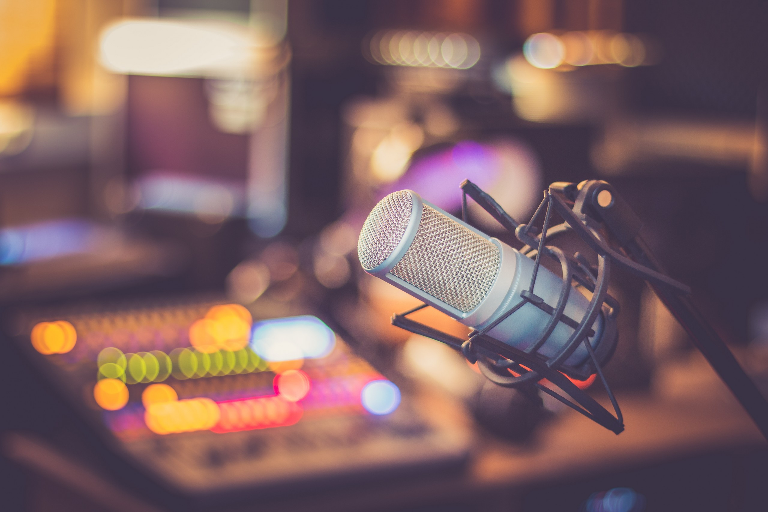 Microphone in a professional recording or radio studio, equipment in a radio stiation blurry background