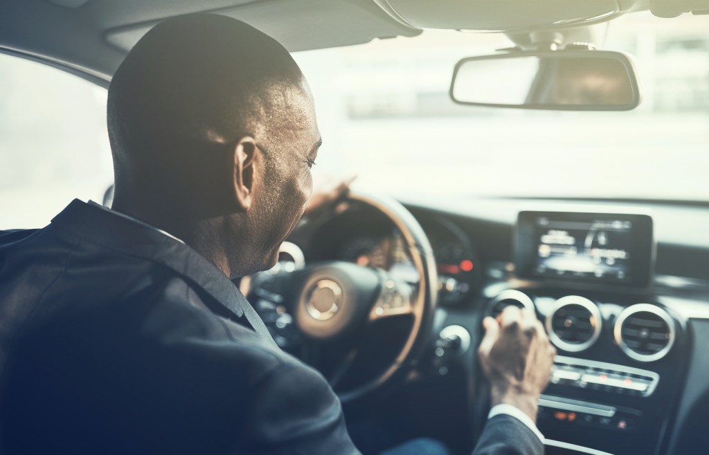 Man listening to radio in car