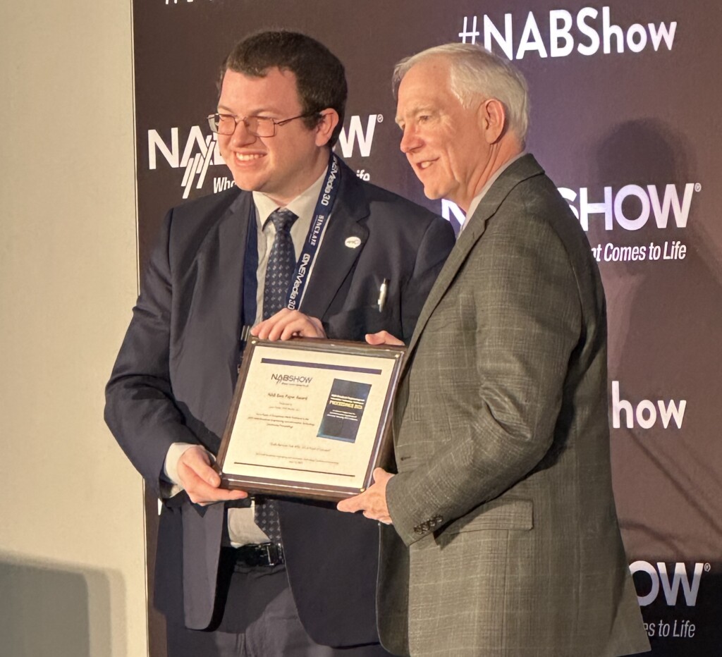 Liam Power (left), systems engineer, ONE Media, receiving the 2023 NAB Best Paper Award from Lynn Claudy, senior vice president, Technology, NAB.