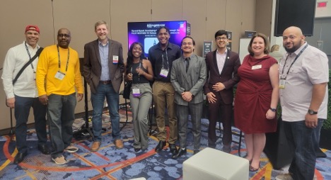 Howard University students and NextGen TV Fellows after demonstrating their weather application at the 2023 NAB Show. Left to Right: WHUT Director of Engineering Louis Crozier, Howard University Associate Professor of Computer Science Dr. Todd Shurn, PILOT Executive Director John Clark, Naisha Flechier, Brent Piper, Bipul Gyawali, Kritish Pokharel, NAP VP of Innovation Alison Neplokh, WHUT General Manager Sean Plater 